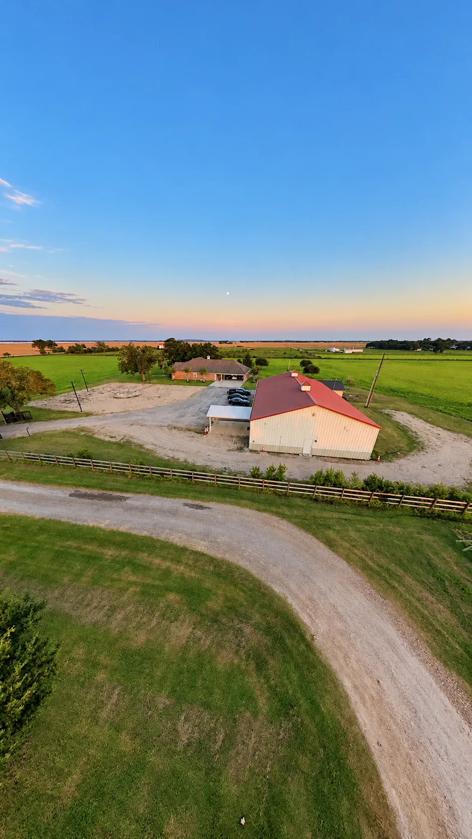 Aerial view of the venue, drive, fence, and surrounding fields at Texas AZ Paradise Ranch in Richmond, Texas.